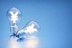 円マークが光る電球が2つ並び、青い背景で光熱費や電気料金をイメージさせるビジュアル